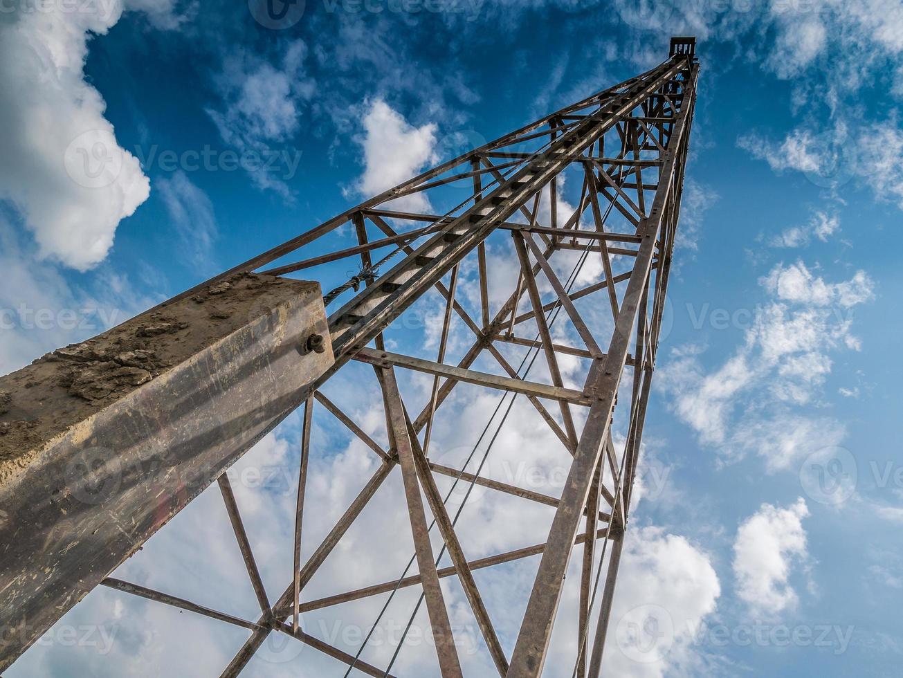 pile driver with clouds and blue sky photo