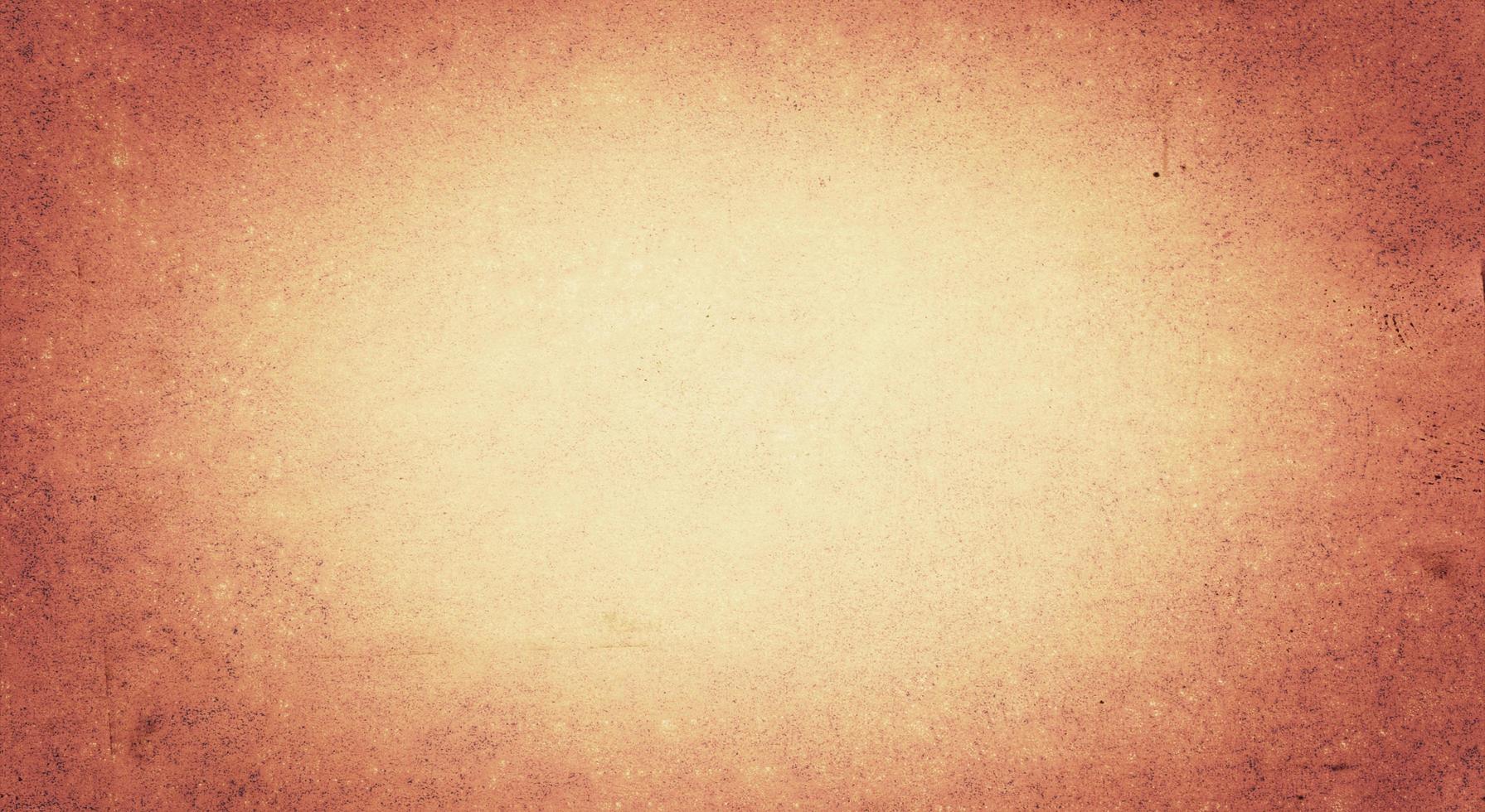 Grunge textured wall background with dark brown vignette border and light center for space text photo