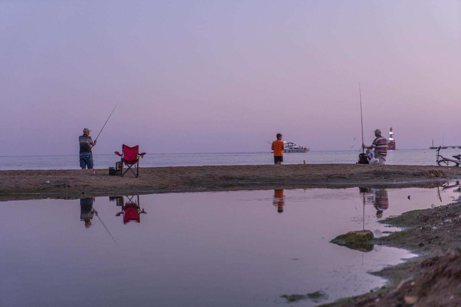 fishing on the sea with sunset photo