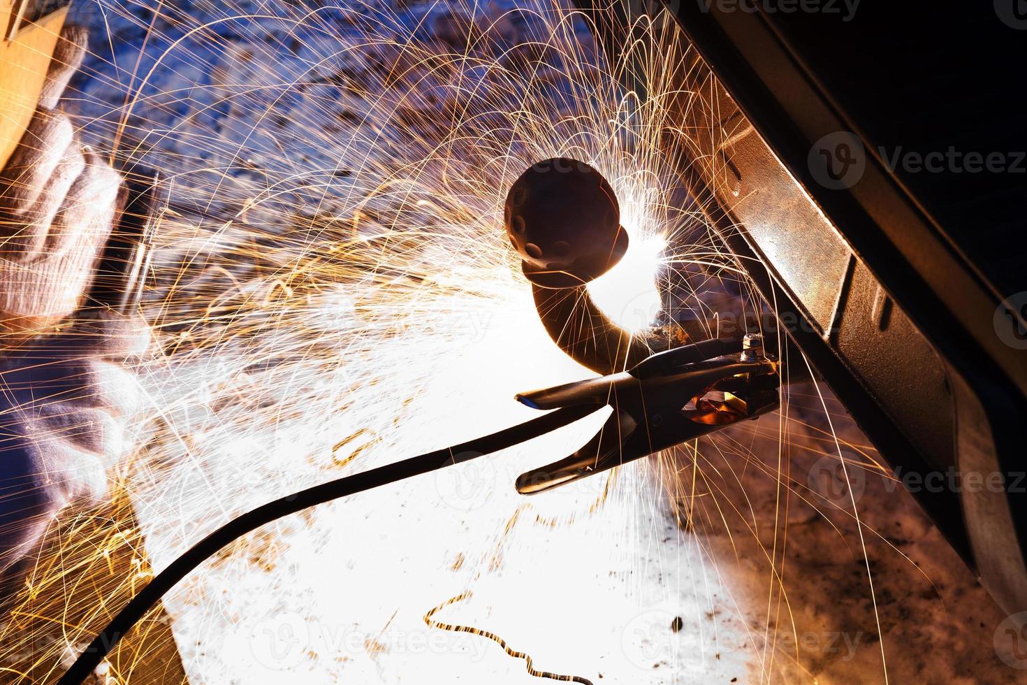 car repairs by welding in snow field photo