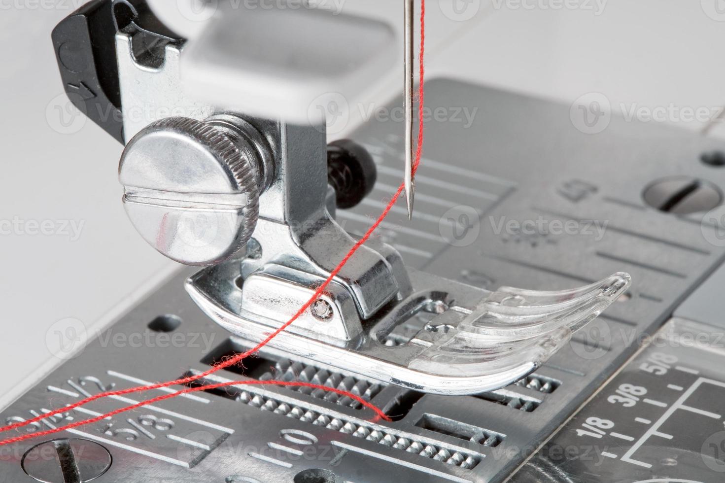 thread in needle of sewing machine photo