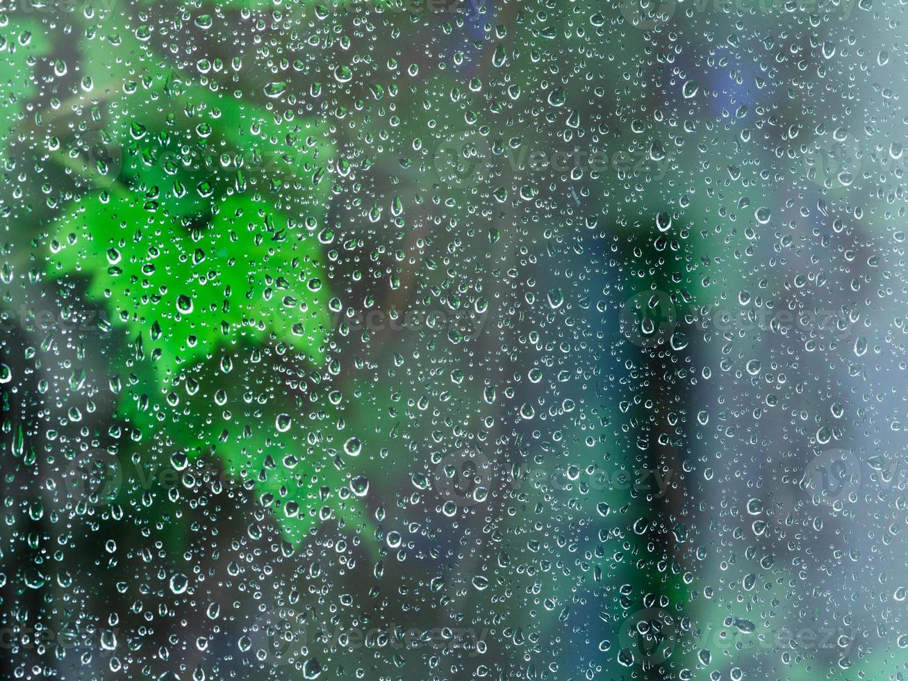 raindrops on window glass during night rain photo