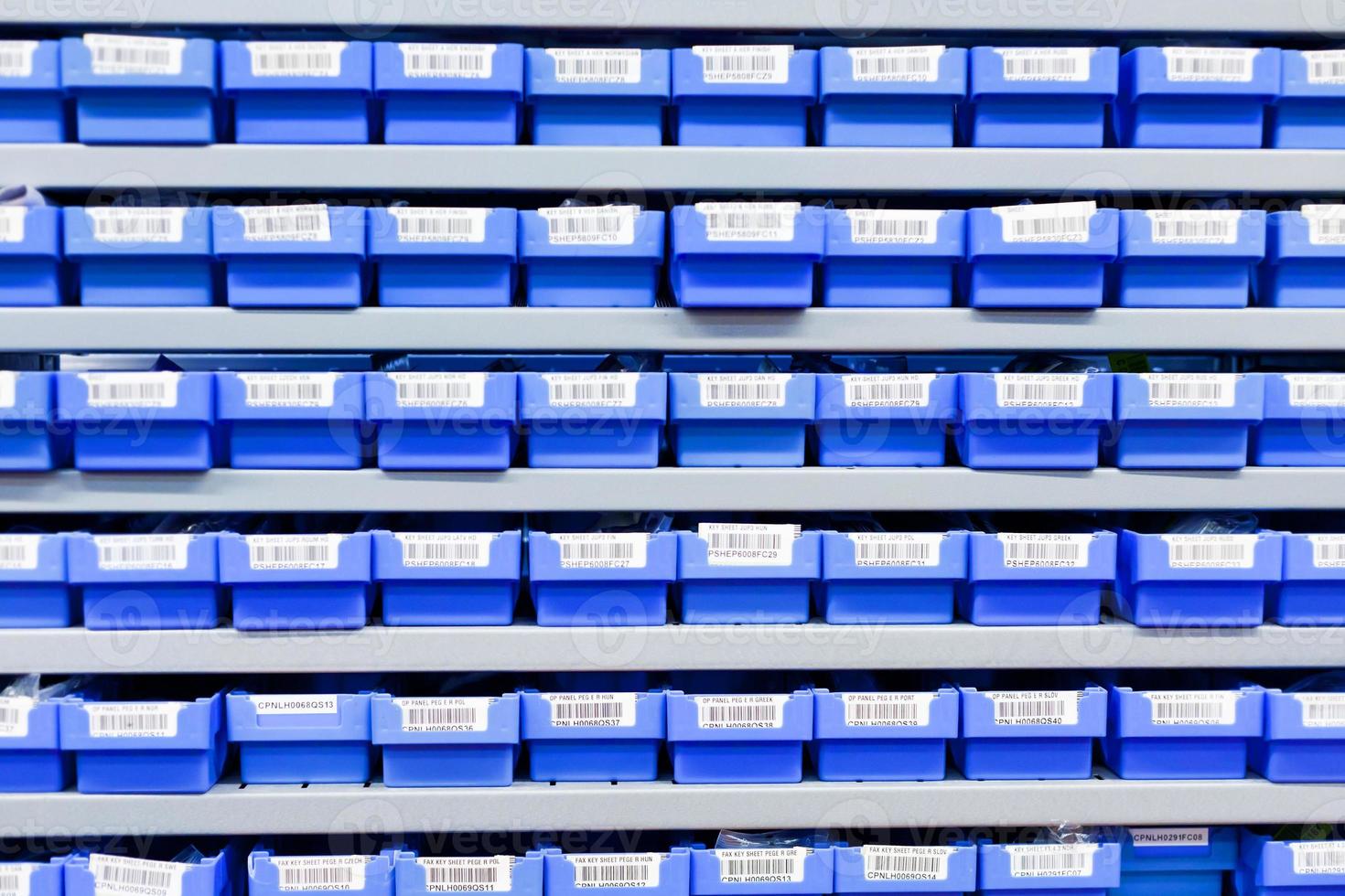 blue plastic boxes in storage stand photo