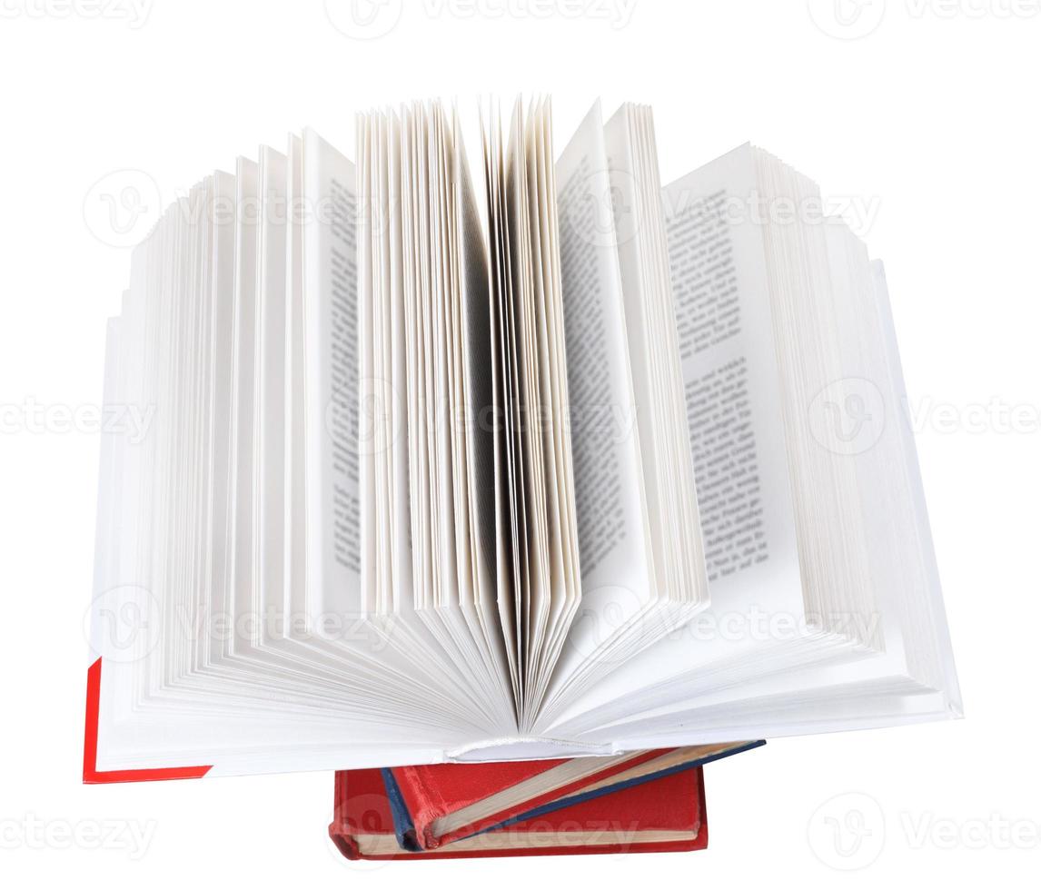 open book on top of stack of books photo