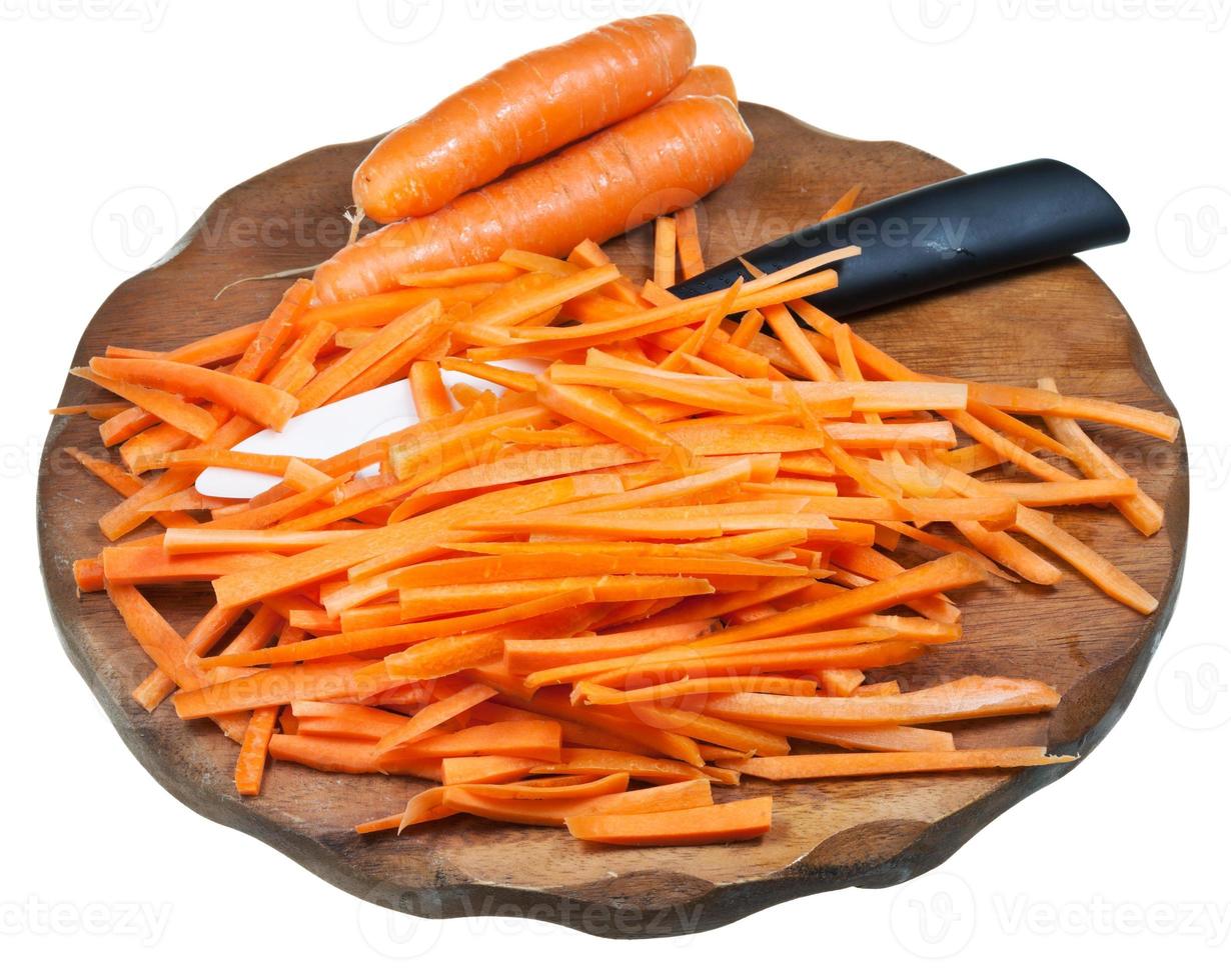 sliced carrot and ceramic knife on cutting board photo