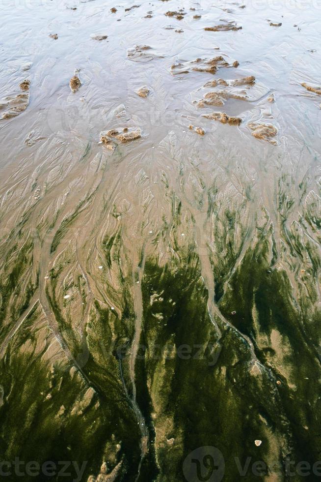 natural pattern on sand beach during evening ebb photo