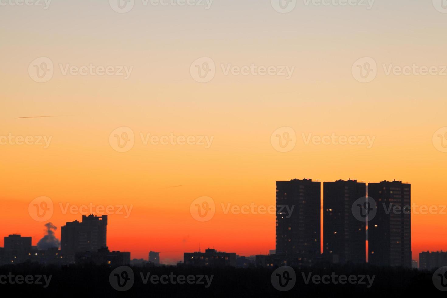 skyline with early morning orange sunrise photo