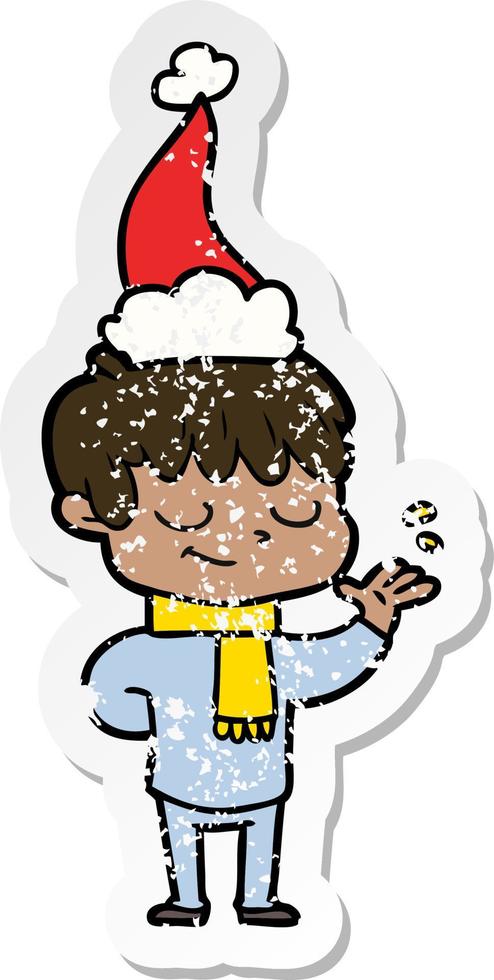 distressed sticker cartoon of a happy boy wearing santa hat vector