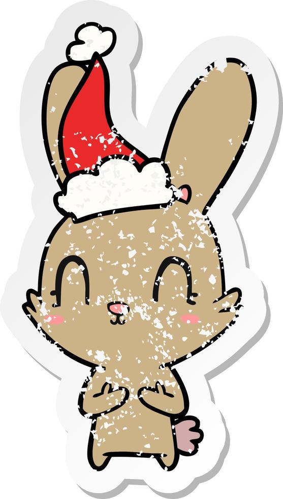 cute distressed sticker cartoon of a rabbit wearing santa hat vector