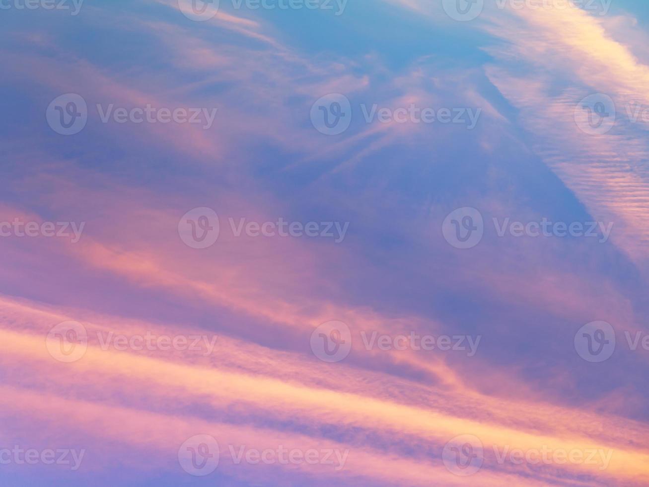 pink sunset clouds in blue evening sky photo