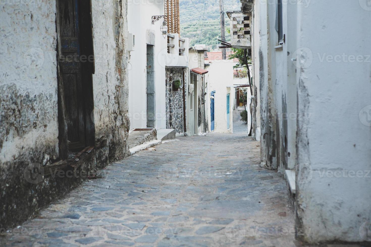 Narrow and colorful street in the village of Kritsa in the island of Crete photo