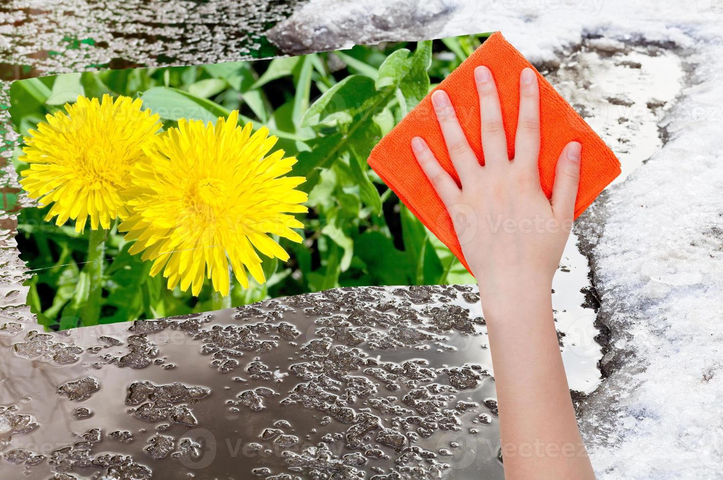 hand deletes melting snow by orange cloth photo