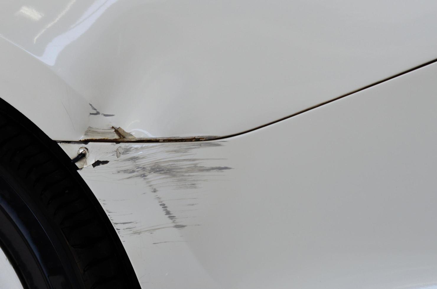 White car accident with abrasions. Concept car insurance business. photo