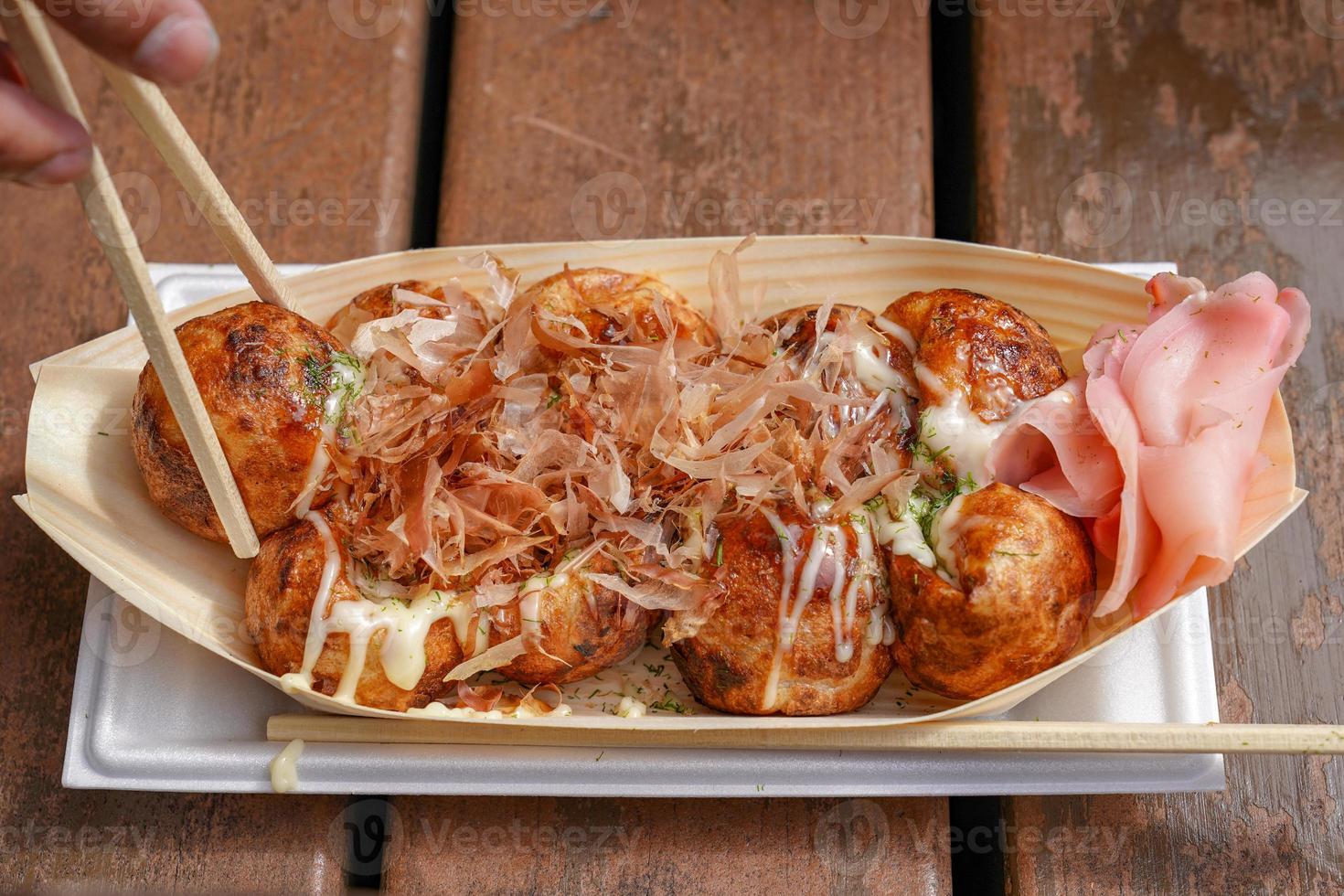 Takoyaki, Local Japanese octopus meat ball on the wood table, ready to eat. photo