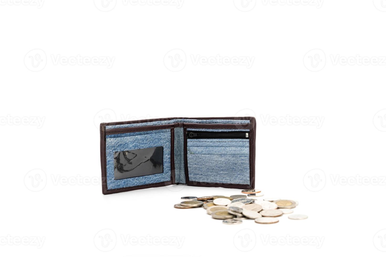 Jean cloth pattern on wallet is opened and standed on white background in studio light with coins beside it. photo