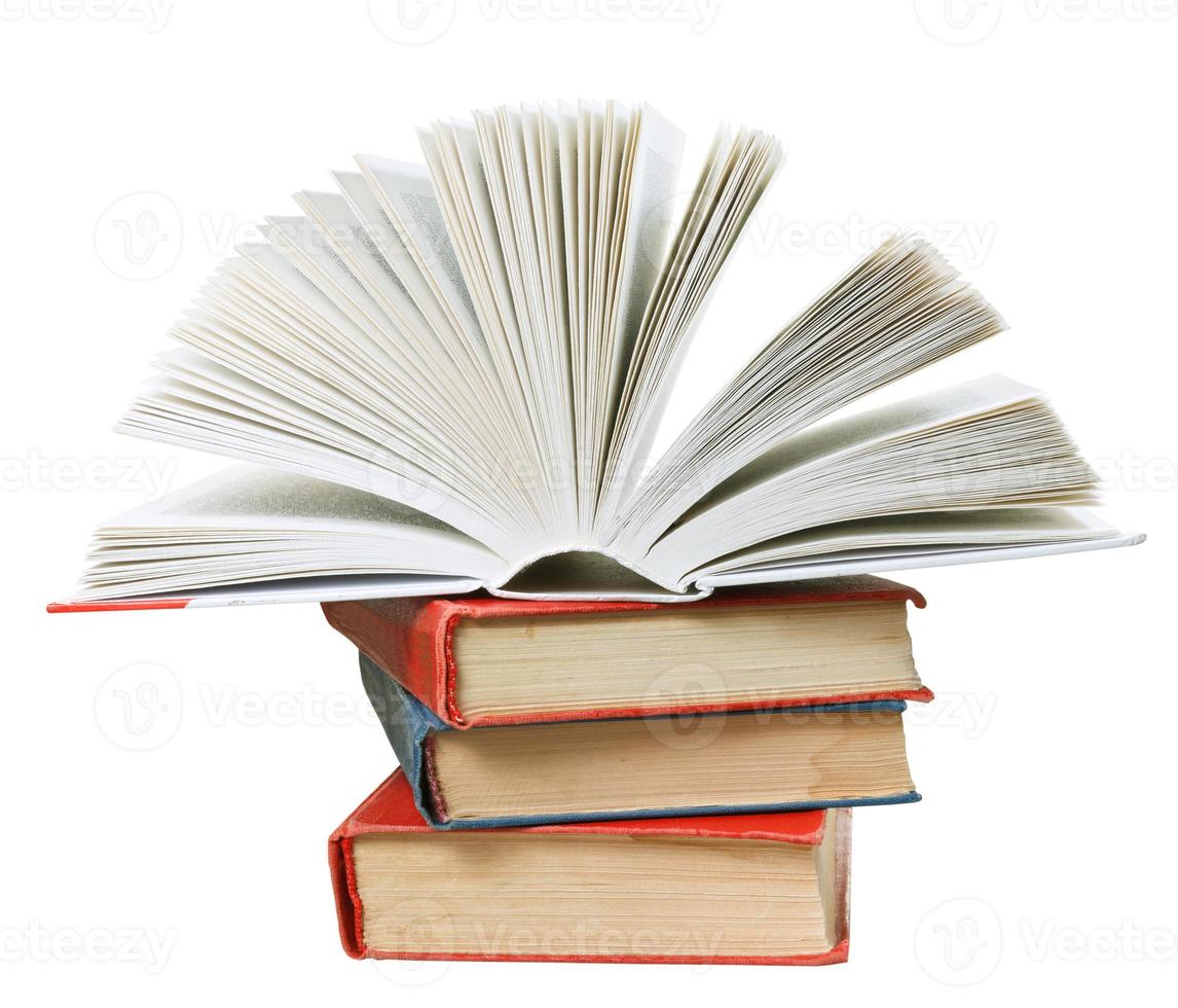 open book on top of stack of books photo