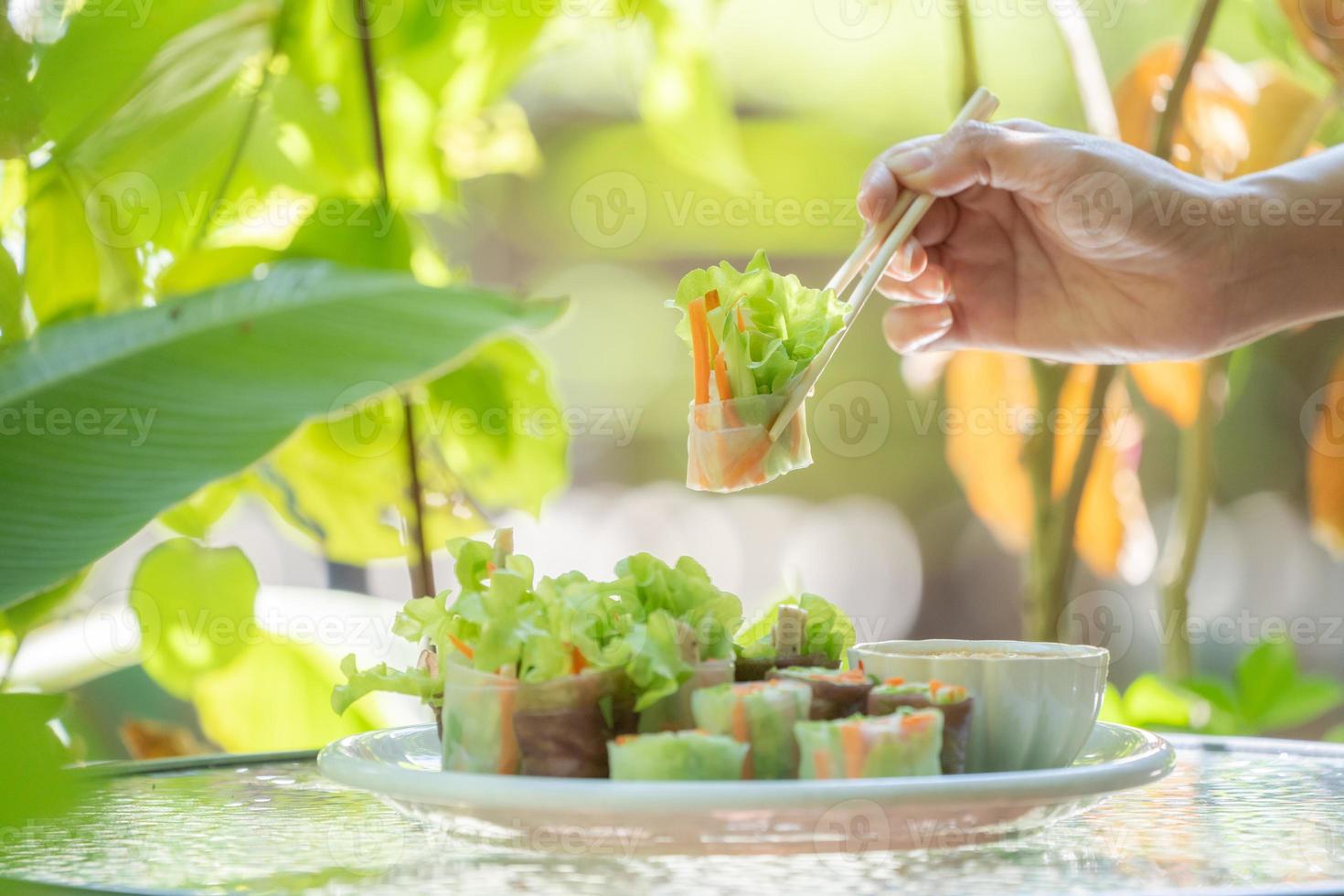 Thai fresh spring roll or  Fresh Vegetable Rice Wraps is the vegetable inside the roll. Eat with specific sauce beside it. photo