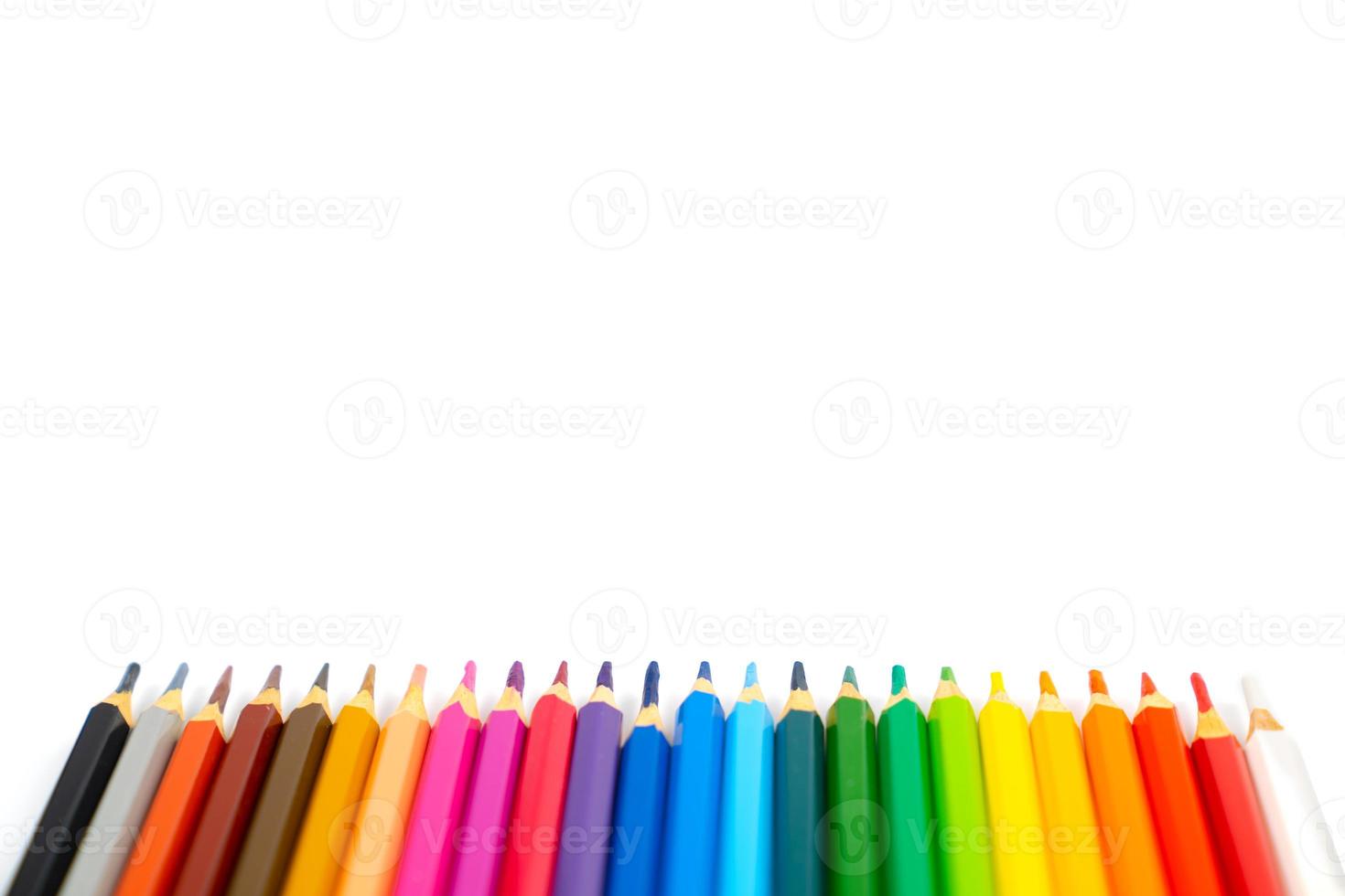 blunt colour pencils are arranged in the line on the white background and ready to paint. photo