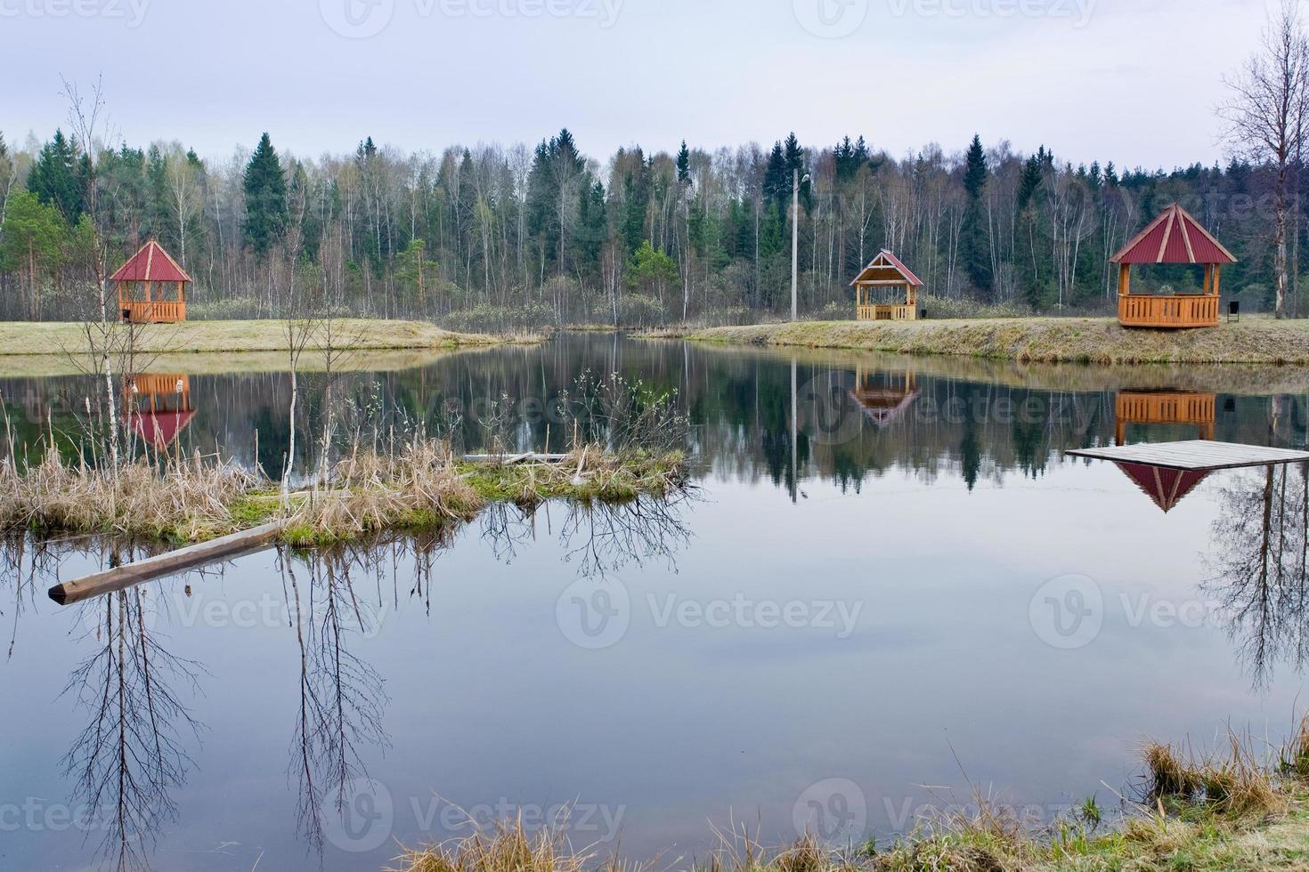 wood pavilions on side of pool photo