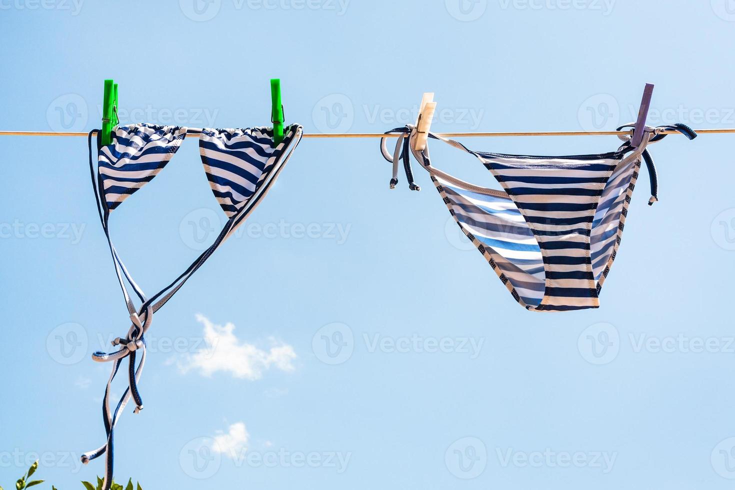 blue Striped swimsuit is dried on clothesline photo