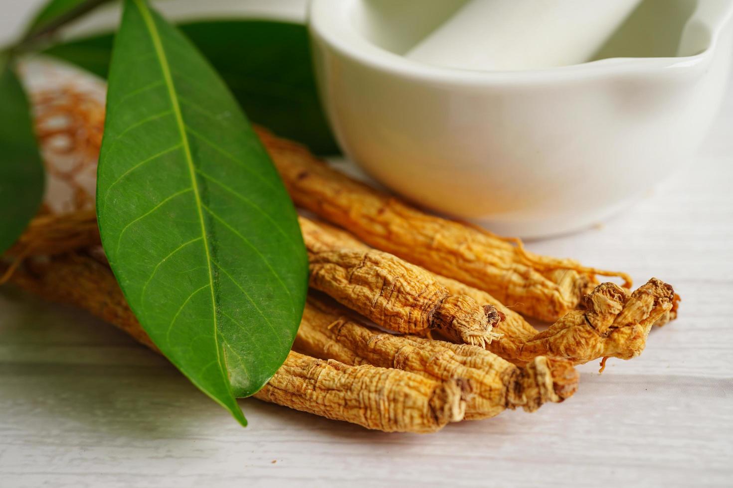 Ginseng roots and green leaf, healthy food. photo