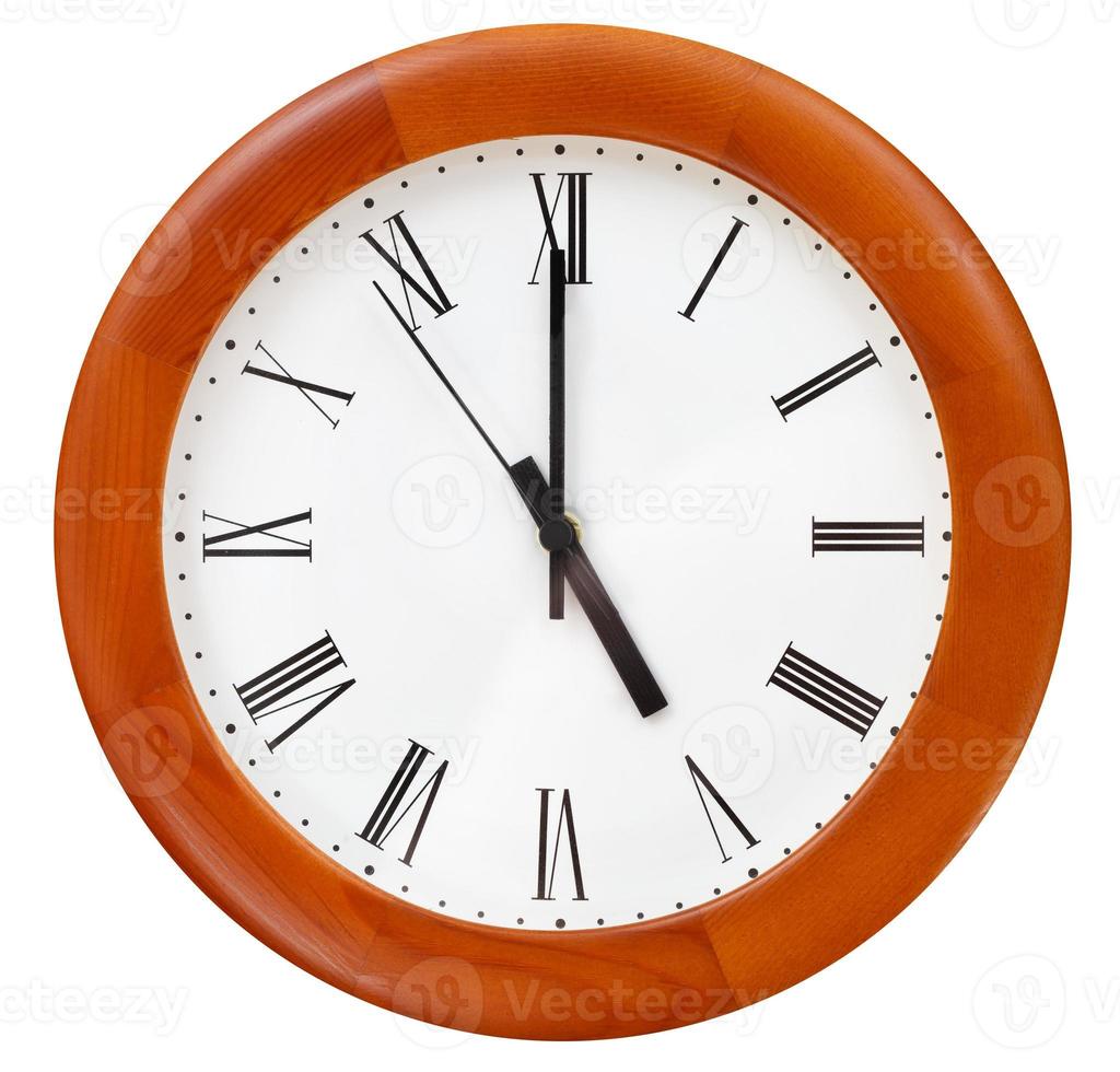 five o clock on round clock photo