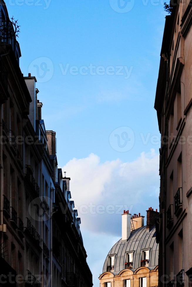 blue spring sky between houses photo