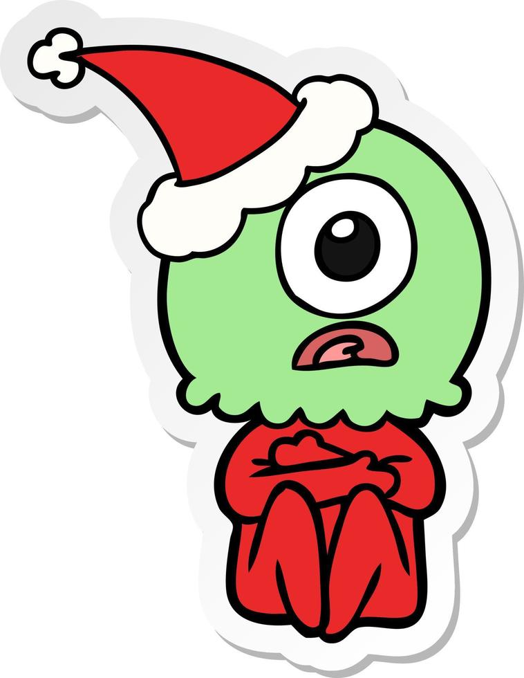 sticker cartoon of a cyclops alien spaceman wearing santa hat vector