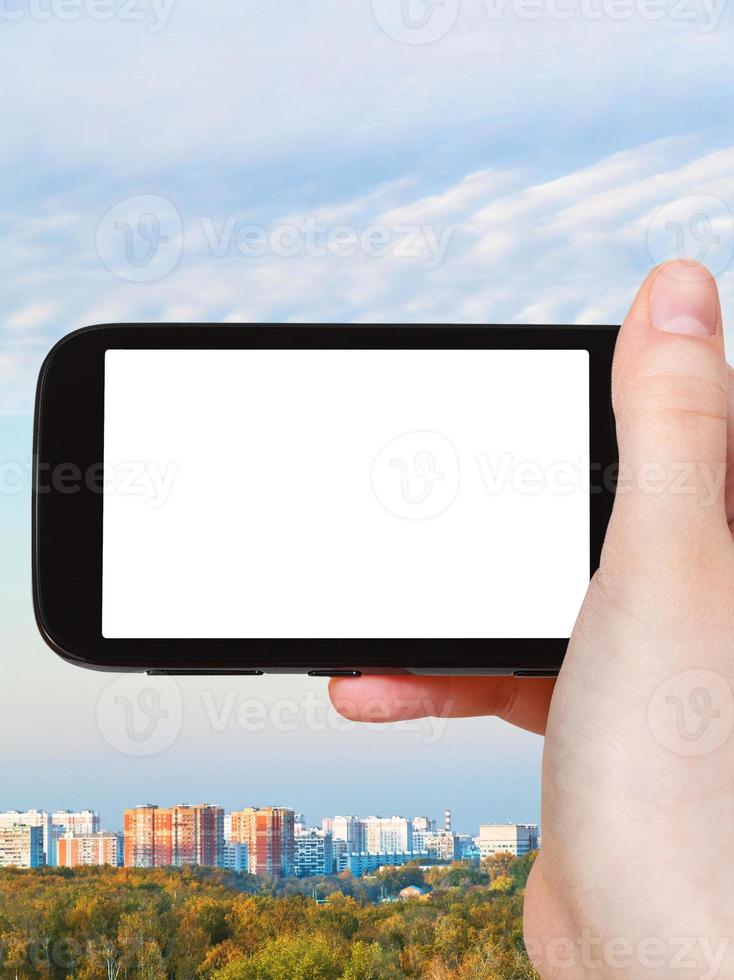 smartphone with cut out screen and city in autumn photo