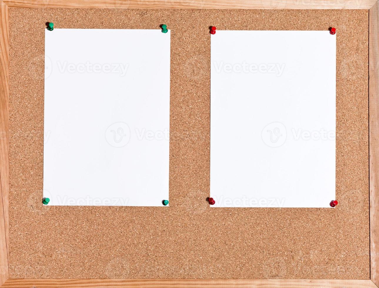 white sheets of paper on cork board photo
