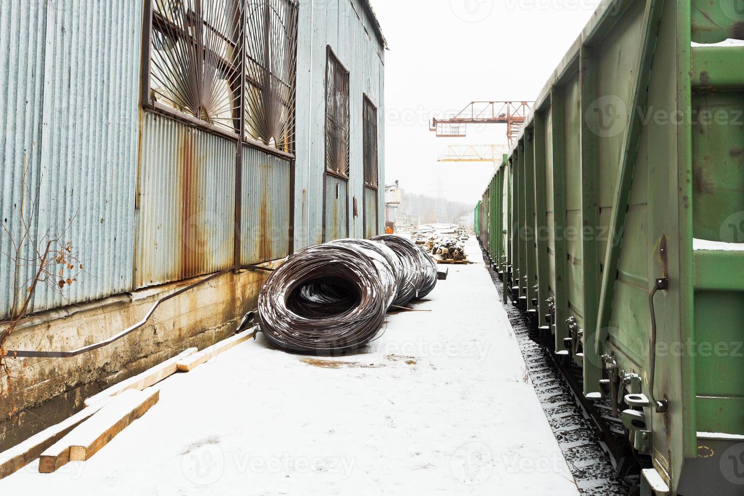 reinforcement rolls near warehouse on railroad photo