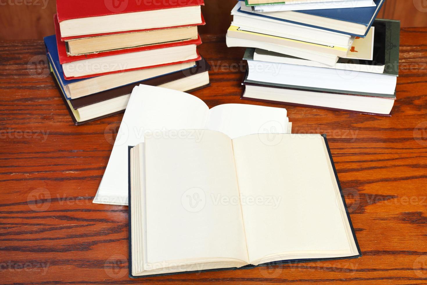 open books on wooden table photo