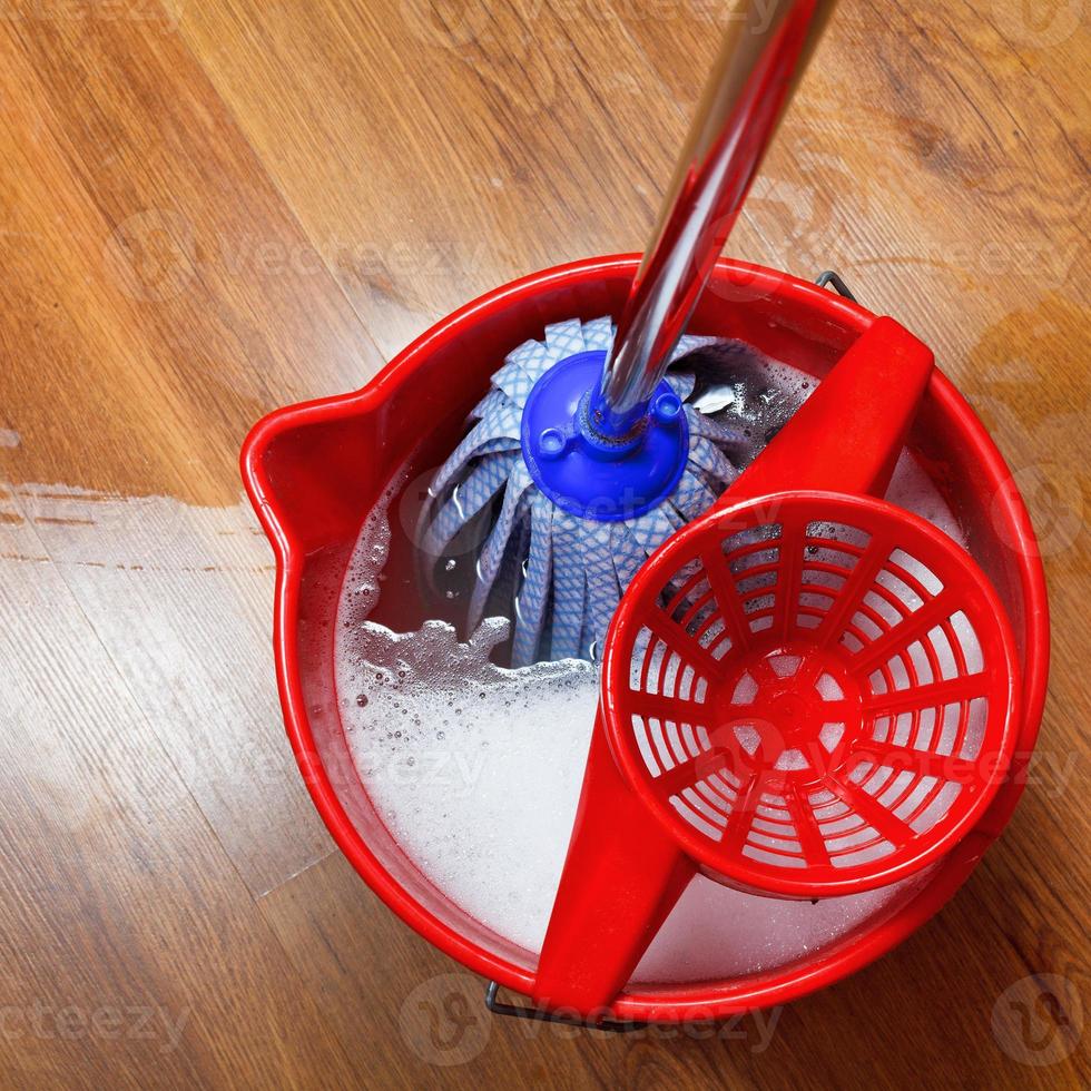 mop in bucket with water photo
