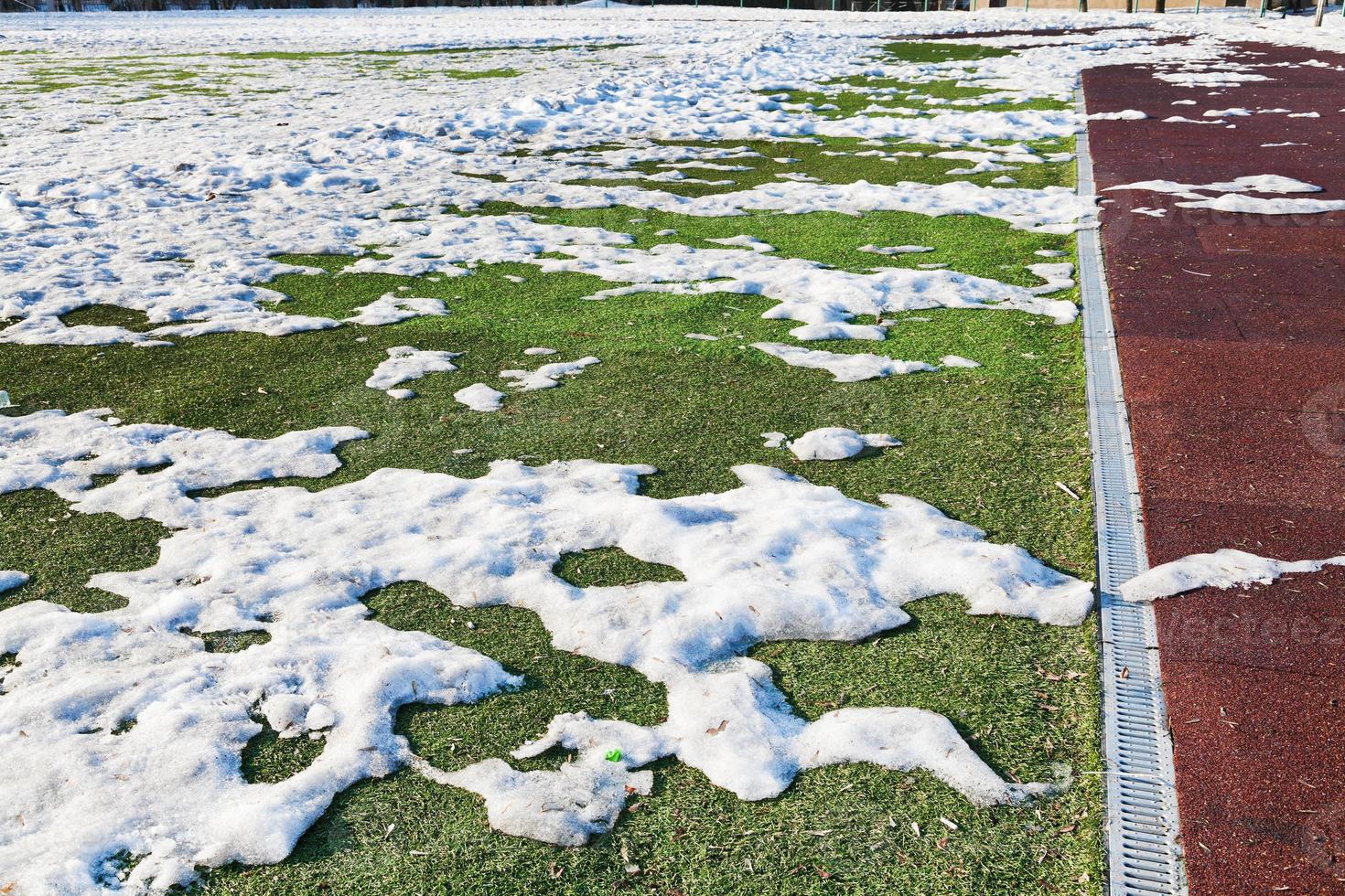 snowdrifts on outdoor soccer field photo
