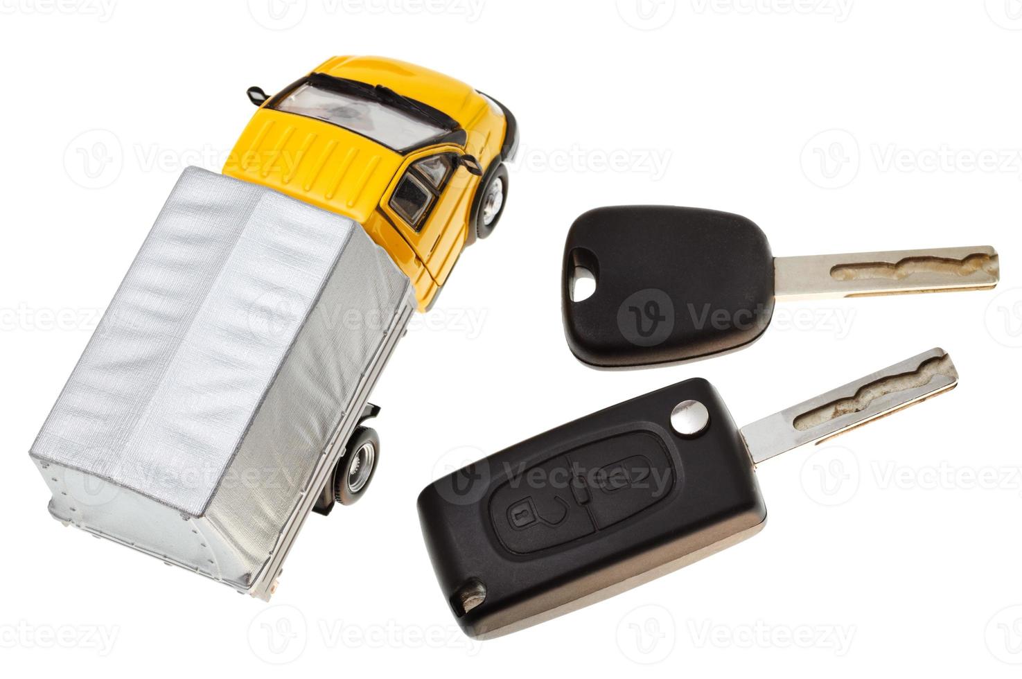 above view of two vehicle keys and truck model photo
