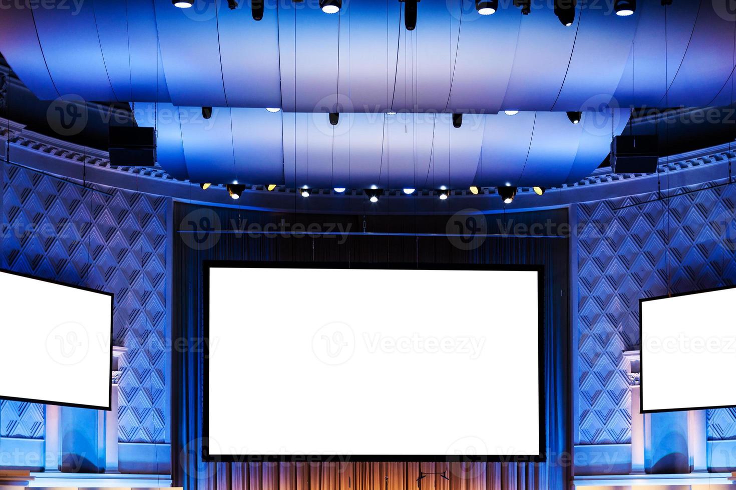 screens in blue illuminated cinema theater photo