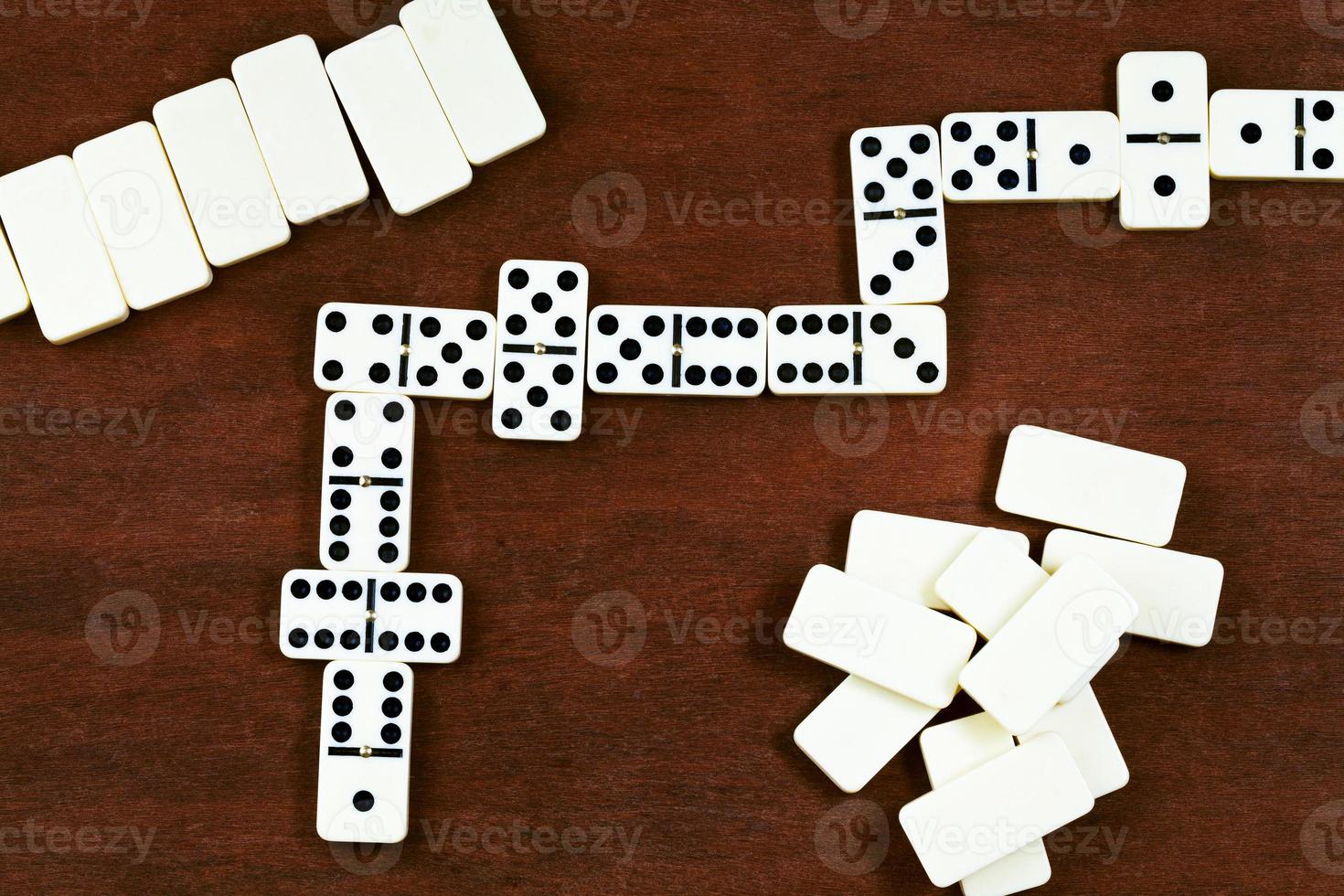 top view of dominoes playing on brown wooden table photo