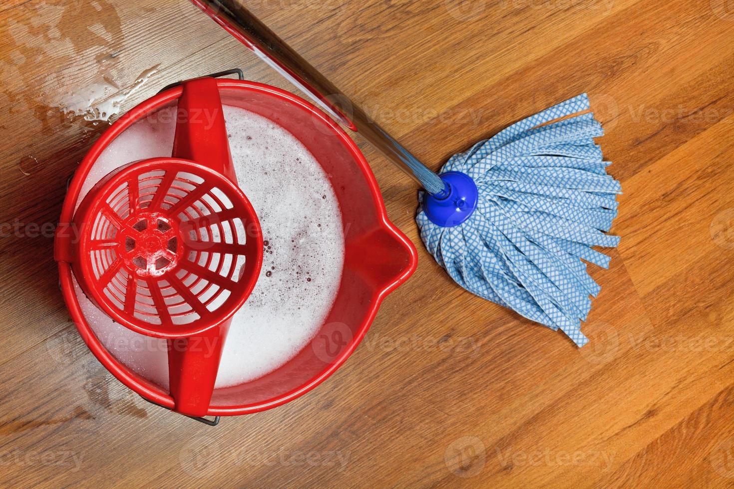 mop and bucket with water for washing floors photo