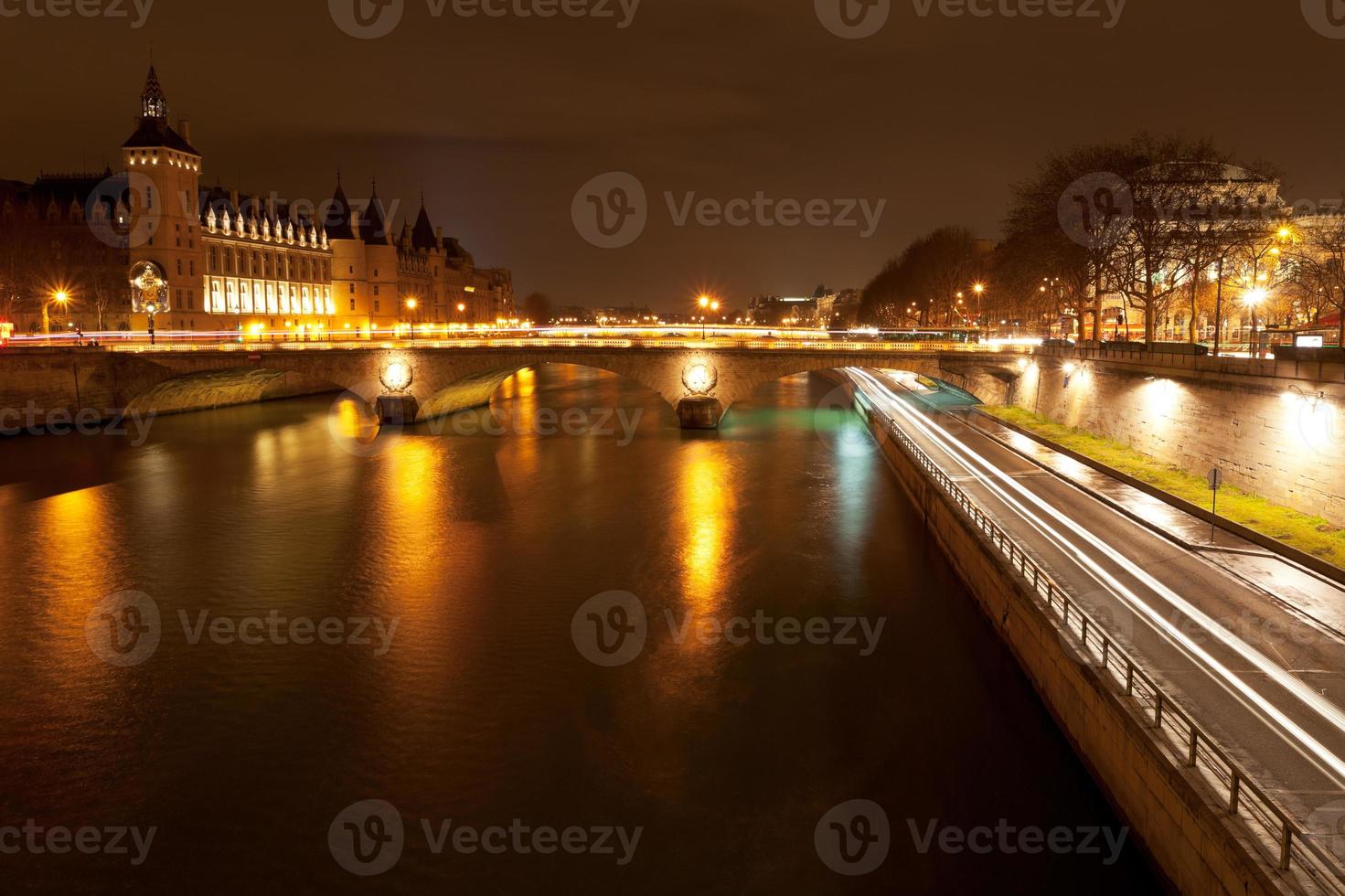 quay and pont au change in Paris at night photo