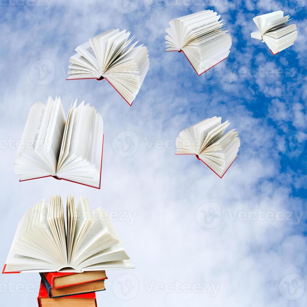 books fly out of pile of books photo