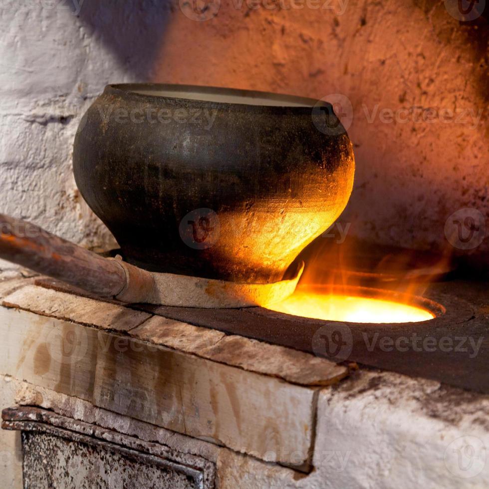russian stove and old iron pot photo