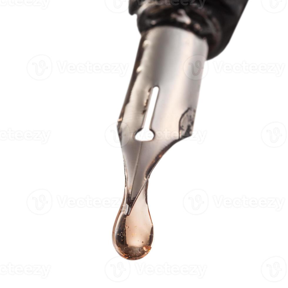 drop of transparent liquid on tip of pen photo