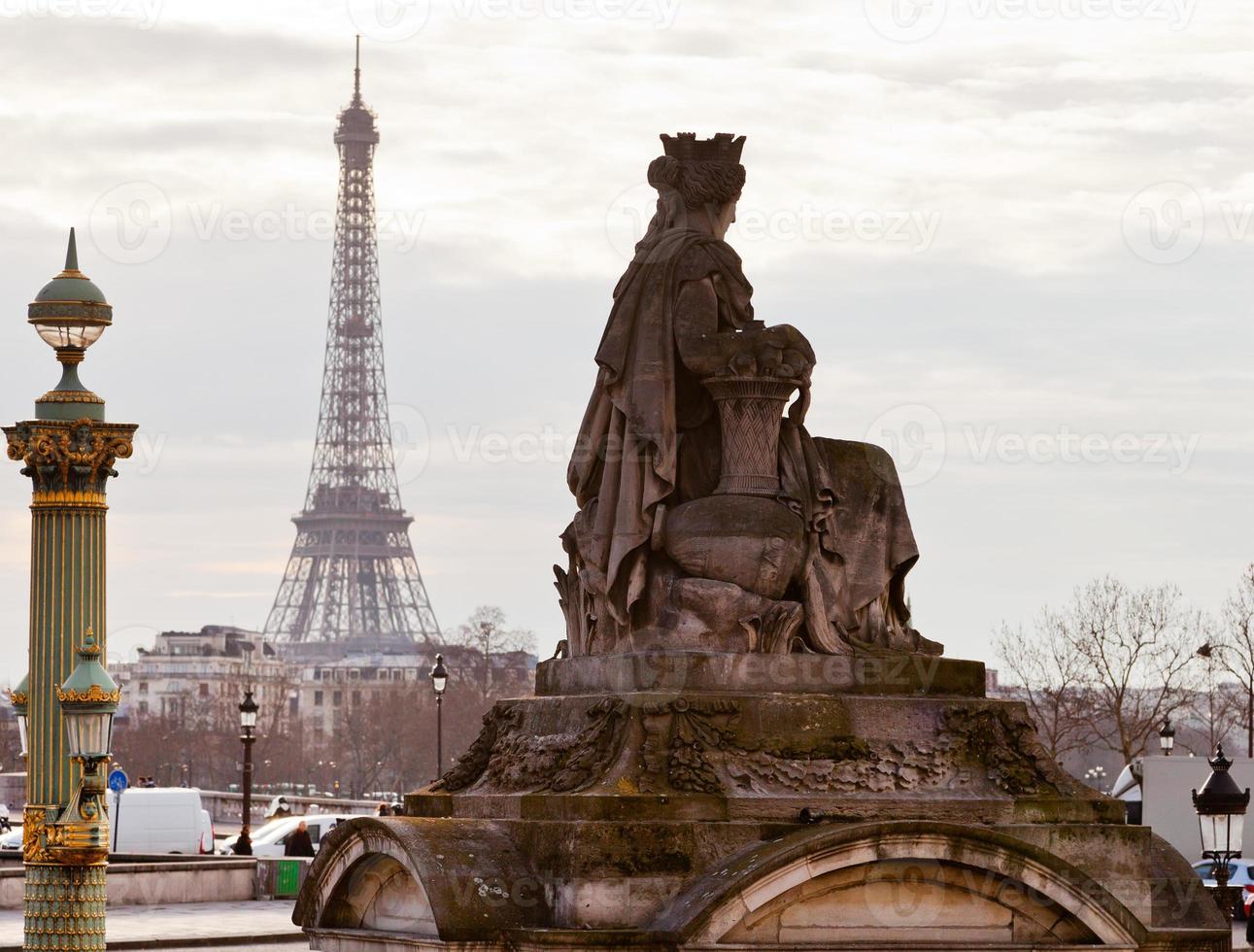 statue, column and Eiffel Tower in Paris photo