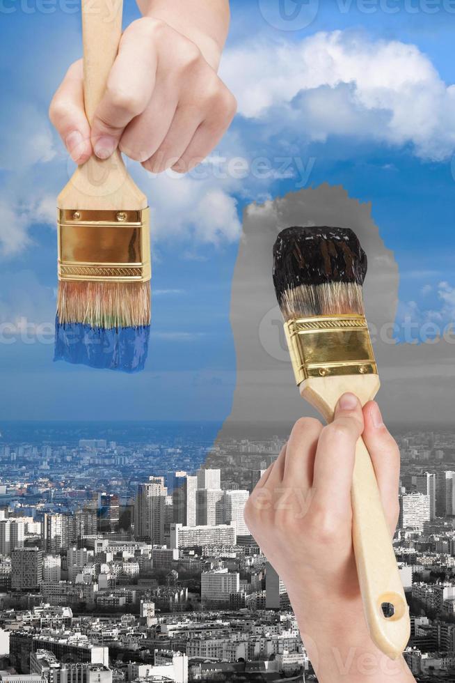 paintbrush paints black and blue side of city photo