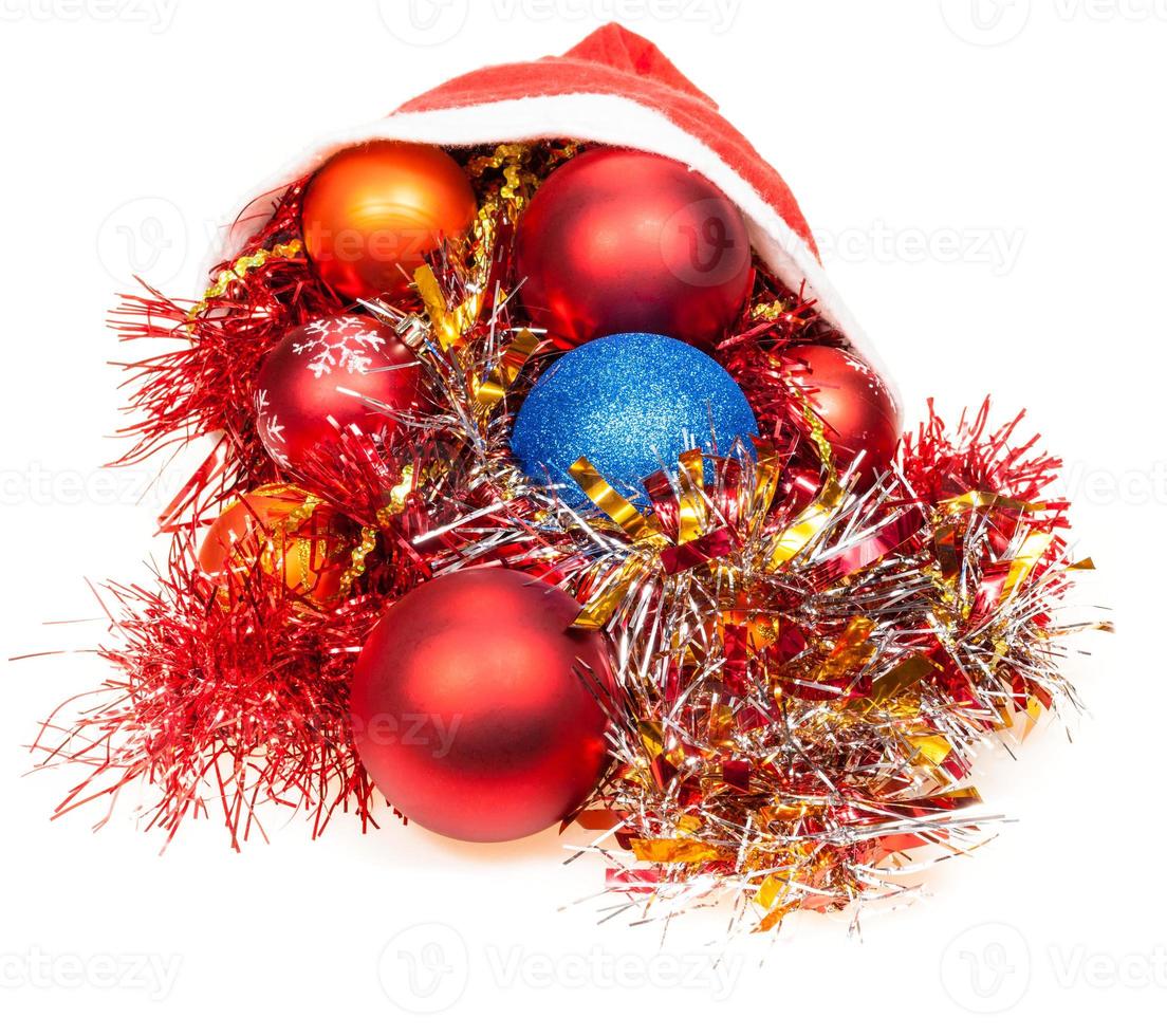 christmas decorations pour out from red santa hat photo