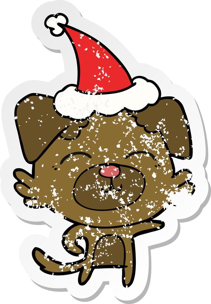 distressed sticker cartoon of a dog pointing wearing santa hat vector