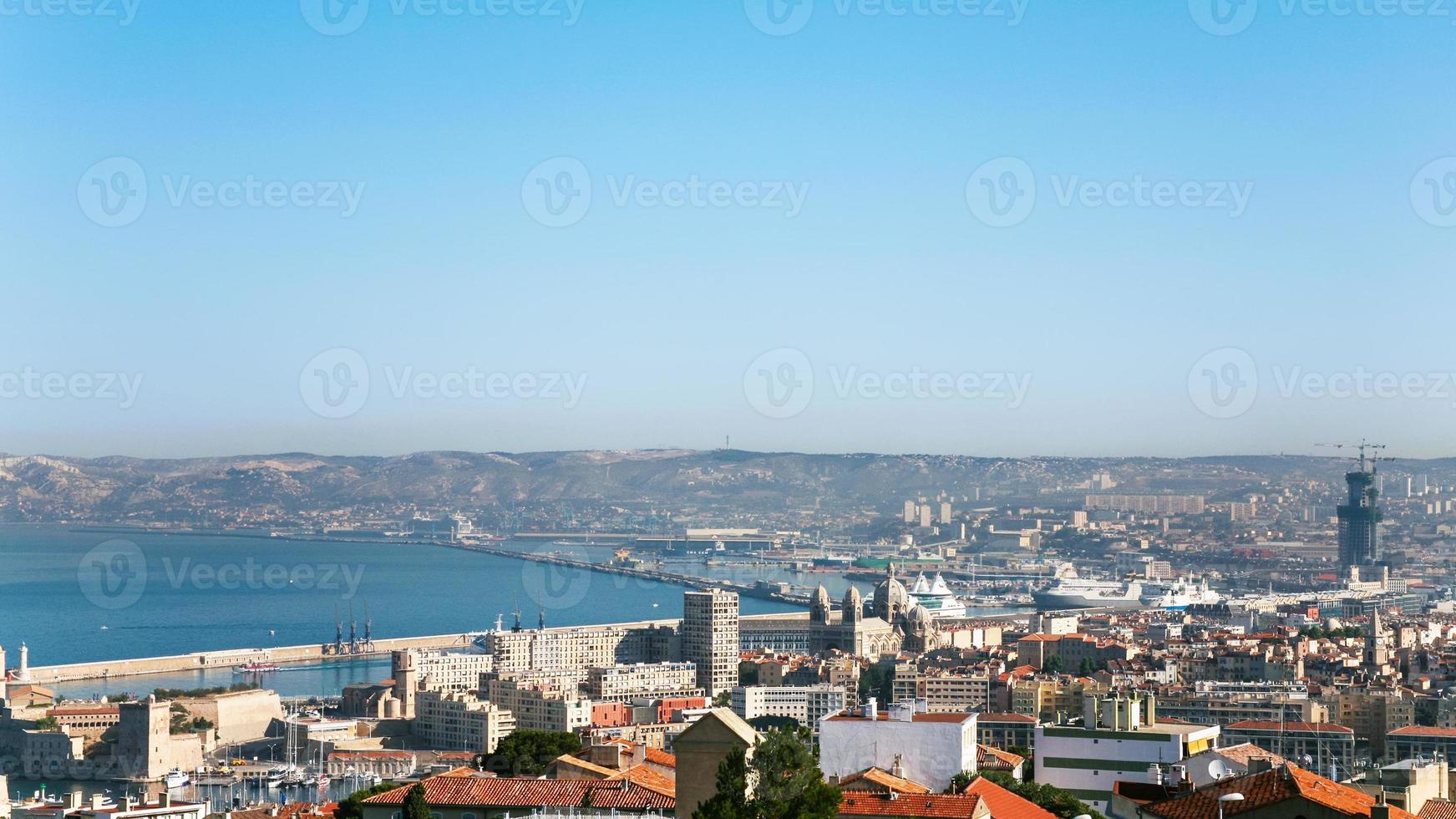 view of Marseilles city and port under blue sky photo