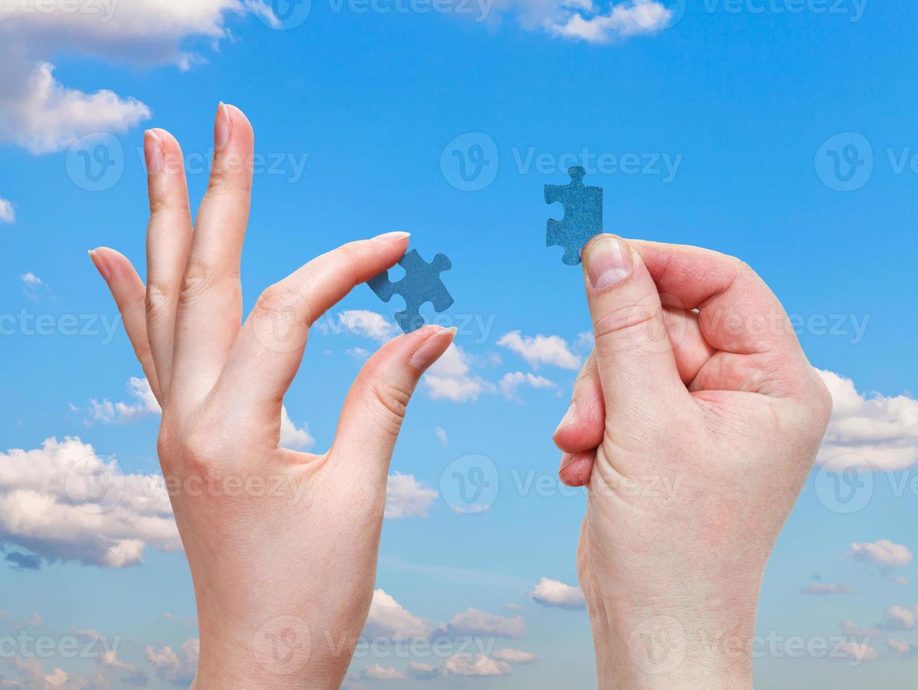 male and female hands with little puzzle pieces photo
