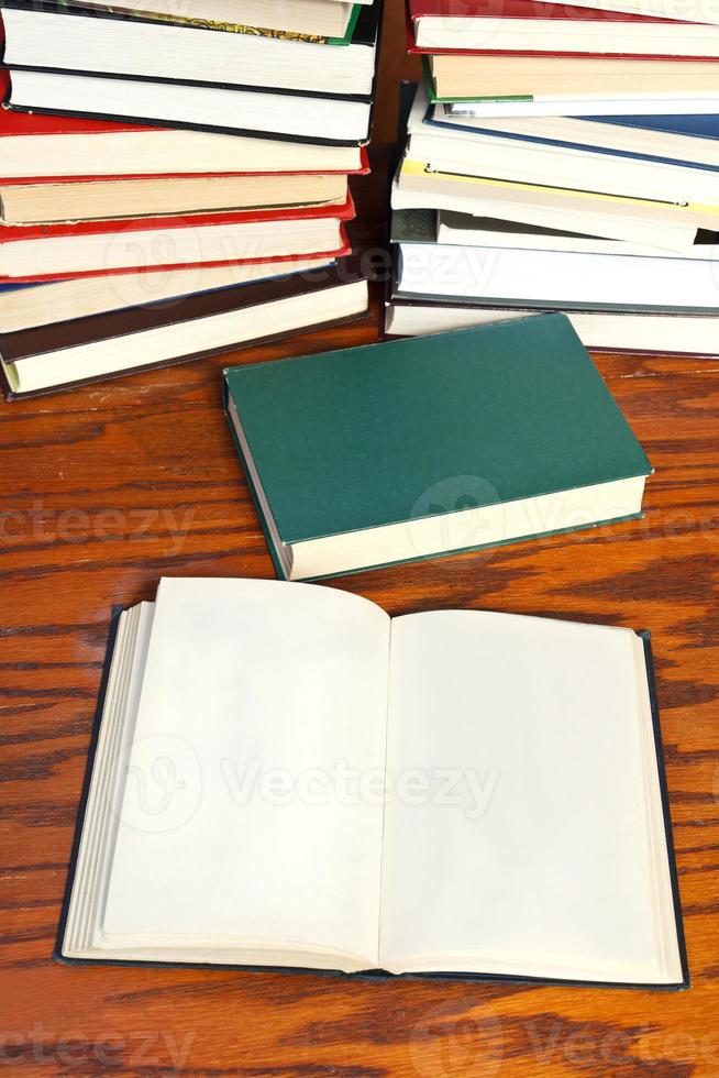 open books on wooden table photo