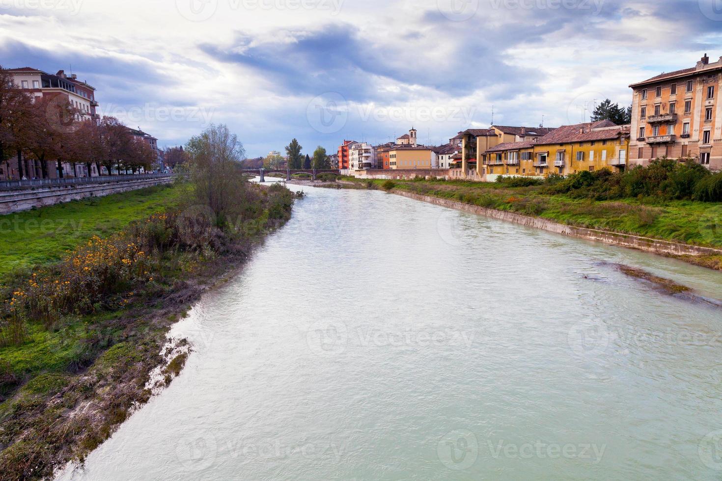 view of bridge through Parma river, Italy photo